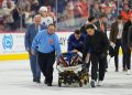 NHL defenseman leaves ice on stretcher after collision
