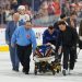 NHL defenseman leaves ice on stretcher after collision